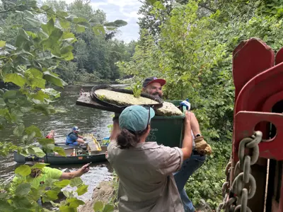 Volunteers loading trash collected from Elkhart River Cleanup event