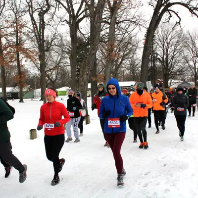 Runners participating in the Frosty Five Run with snow on the ground