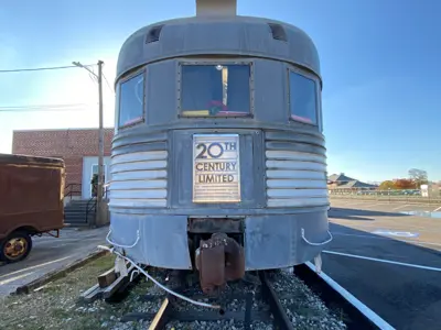 Photo of the end of the City of Elkhart Observation Car at the NNYCRRM. The car's back plate is the 20th Century Limited logo.