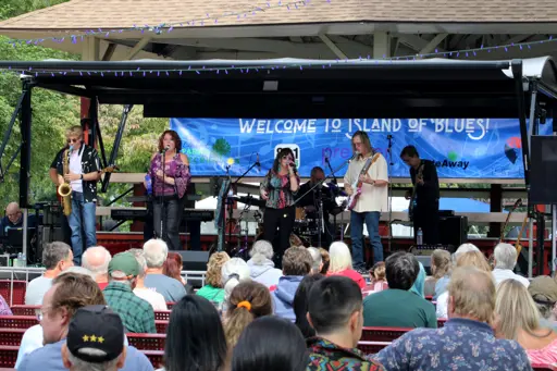 Band performing on stage with the audience enjoying Island of Blues