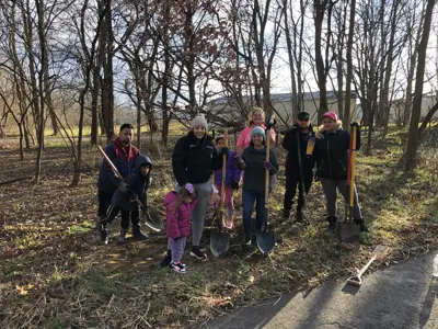 Volunteer group photo planting trees along River Greenway Trail
