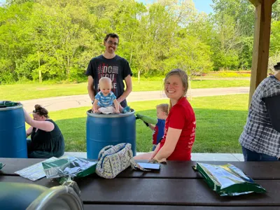 Family building a rain barrel at program at EEC