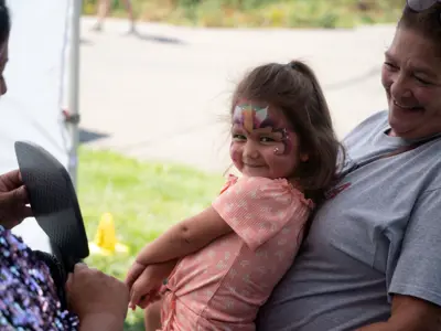 Little girl with face paint at Waggin' in the Woods event