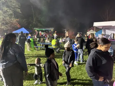 Food vendors and music stage at night at Haunted Walk event