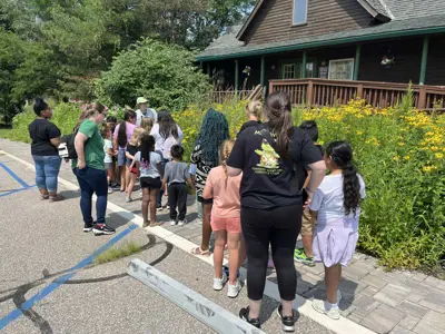 EEC staff teaching kids about rain garden