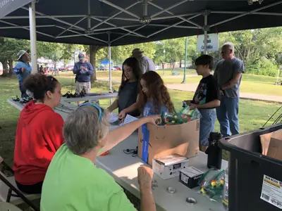 Volunteers giving away free rods and reels at Kids Free Fishing Clinic
