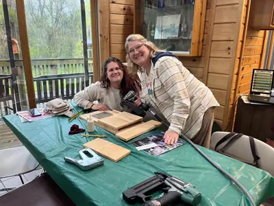 Group making bat house at program at EEC