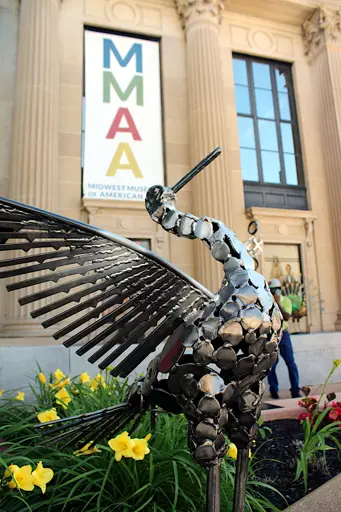 Metal sculpture by a local artist with the Midwest Museum of American Art in the background