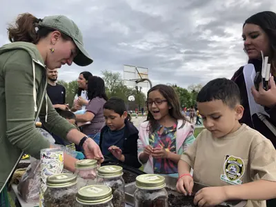 EEC staff helping kids make seed balls